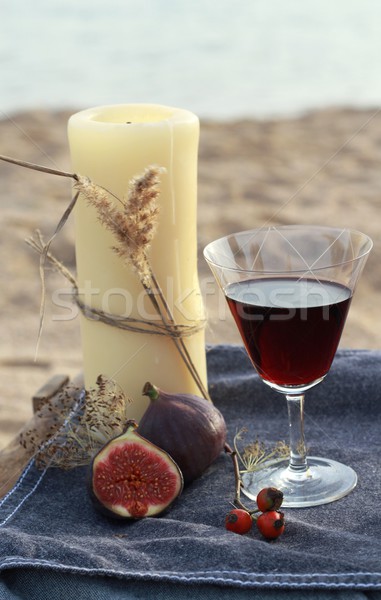 Candle and red wine on the beach  Stock photo © laciatek