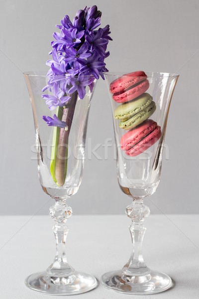 Stock photo: Glass with french macaroons and flowers