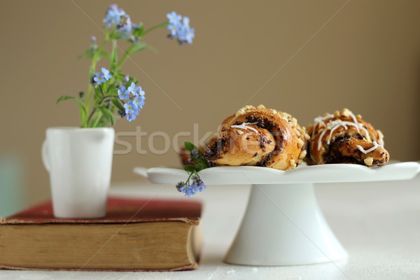 Book with flowers forget-me-not on the vintage book and croissants Stock photo © laciatek