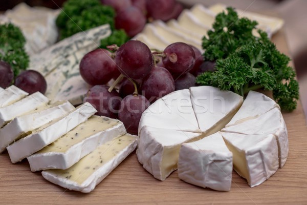 Cheese board: Camembert with herbs decorated with grapes and parsley Stock photo © laciatek