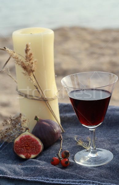 Candle and red wine on the beach  Stock photo © laciatek