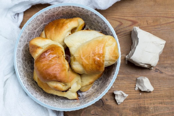 homemade yeast croissants in a ceramic bowl and raw yeast on a wooden background Stock photo © laciatek