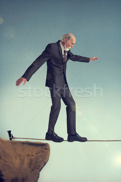 senior man walking a tightrope Stock photo © leeavison