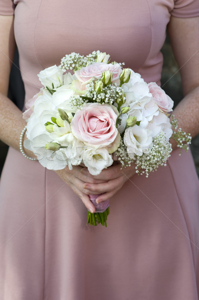 bridesmaid holding a wedding bouquet of pink flowers Stock photo © leeavison