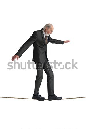 Idős férfi sétál kötéltánc izolált fehér Stock fotó © leeavison
