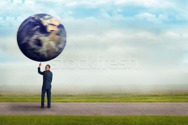 businessman holding planet earth with one finger  Stock photo © leeavison