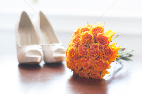 wedding shoes and bouquet of orange roses Stock photo © leeavison