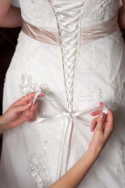 Stock photo: tying the bow of a wedding dress