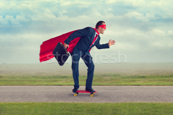 superhero businessman riding a skateboard Stock photo © leeavison