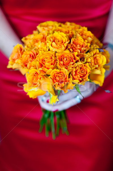 Narancs rózsa virágcsokor nő vörös ruha tart Stock fotó © leeavison