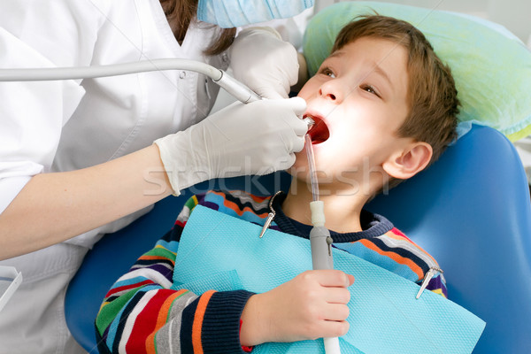 Boy and dentist during a dental procedure Stock photo © leedsn