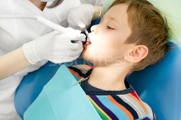 Boy and dentist during a dental procedure Stock photo © leedsn
