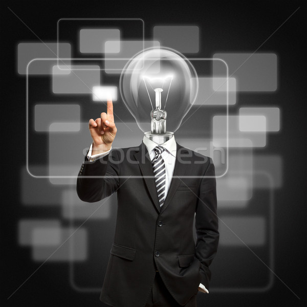 Stock photo: businessman with lamp-head push the button