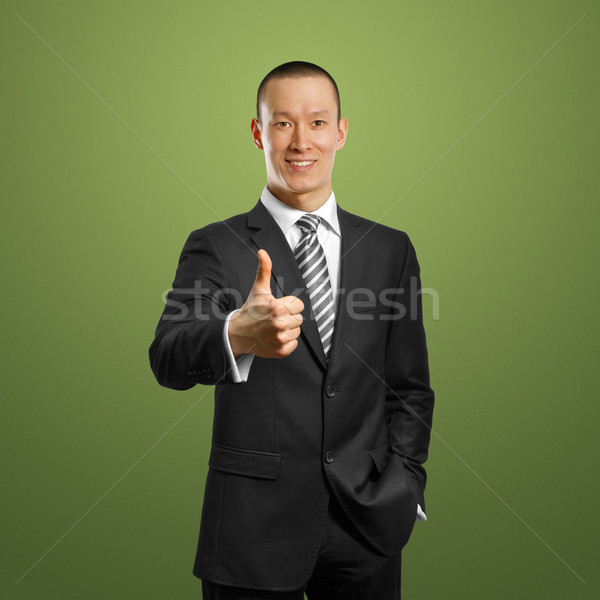 asian businessman in black suit shows well done Stock photo © leedsn