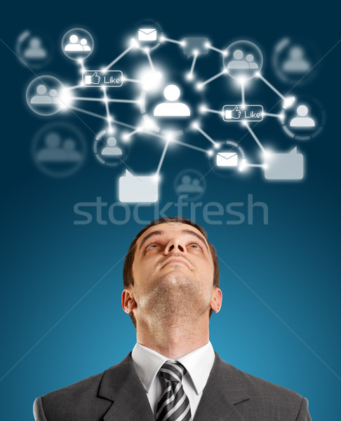 Businessman Looking Upwards in Social Network Stock photo © leedsn
