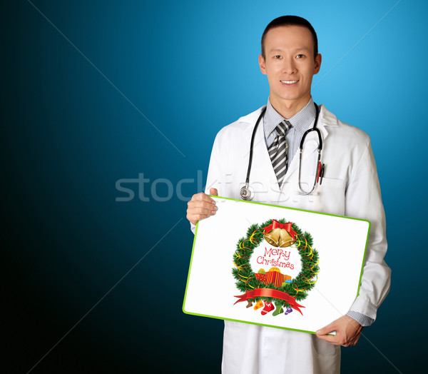 doctor with empty board with Merry Christmas picture Stock photo © leedsn