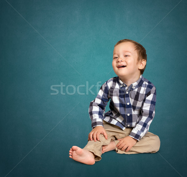 Cute boy siting on the floor Stock photo © leedsn
