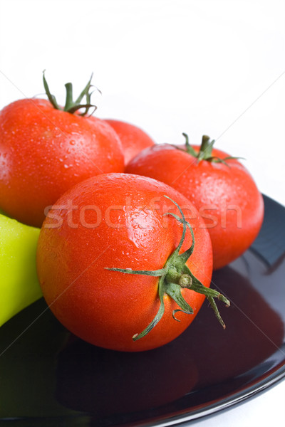 Paradicsomok friss fekete kerámia tányér közelkép Stock fotó © Leftleg
