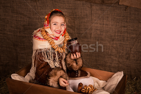 Beautiful russian girl in a shawl  sitting in a cart  Stock photo © Len44ik