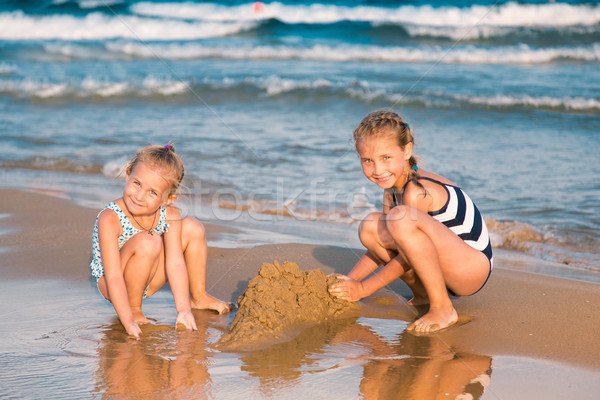 Adorable little girls playing at the seashore Stock photo © Len44ik