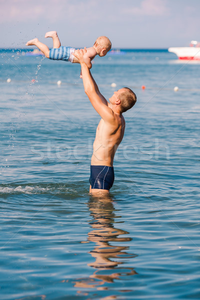 Happy father and baby having fun in the sea Stock photo © Len44ik