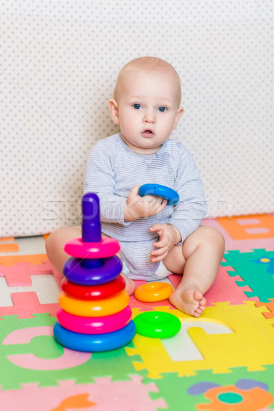 Cute little baby playing with colorful toys Stock photo © Len44ik