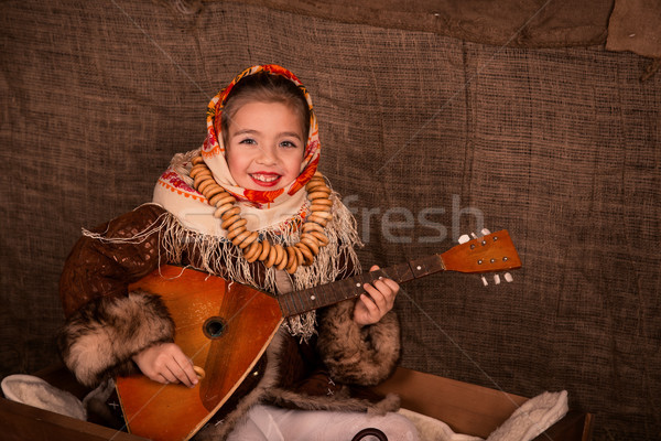 Beautiful russian girl in a shawl  sitting in a cart  Stock photo © Len44ik