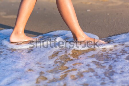 Child walking with bare feet along the seashore Stock photo © Len44ik