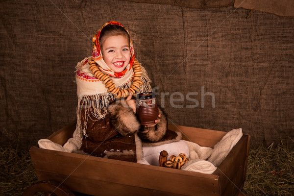 Beautiful russian girl in a shawl  sitting in a cart  Stock photo © Len44ik