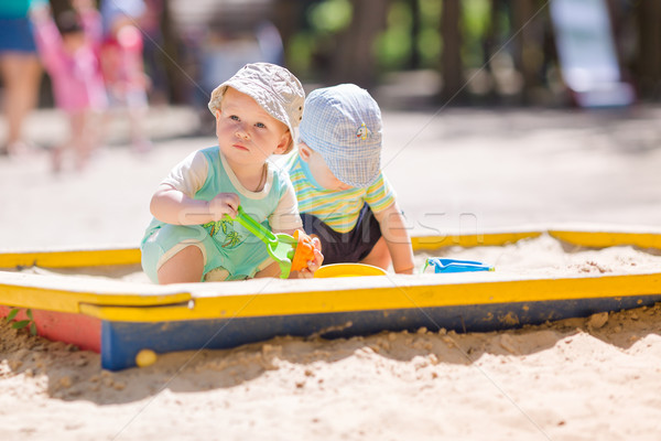 Two baby boys playing with sand Stock photo © Len44ik