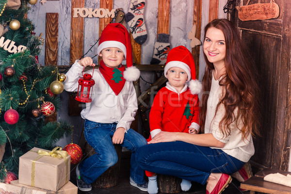 Happy family in Santa's costumes near Xmas tree Stock photo © Len44ik
