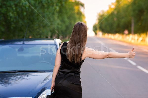 Beautiful businesswoman near her car trying to stop another car Stock photo © Len44ik