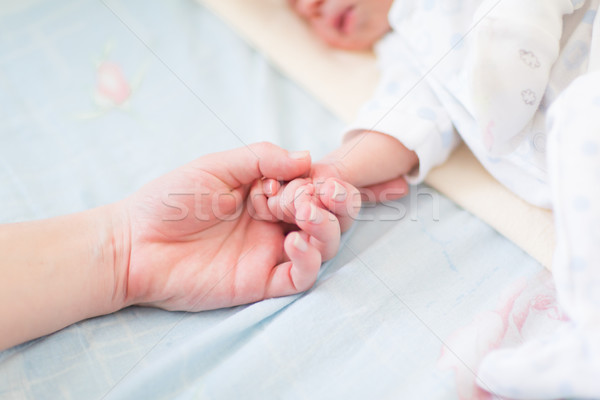 Mother holding the hand of her new born baby Stock photo © Len44ik