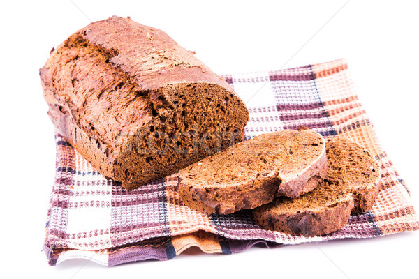 Fresh sliced homemade brown bread with cereals on a kitchen towel Stock photo © Len44ik