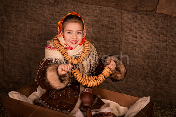 Beautiful russian girl in a shawl  sitting in a cart  Stock photo © Len44ik