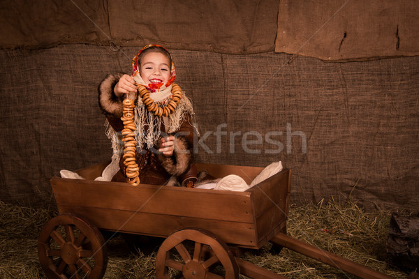 Beautiful russian girl in a shawl  sitting in a cart  Stock photo © Len44ik
