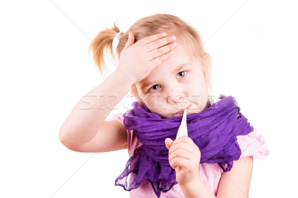 Sick little girl with chickenpox measuring temperature and checking her forhead Stock photo © Len44ik
