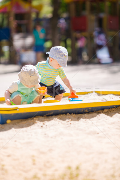 Two baby boys playing with sand Stock photo © Len44ik
