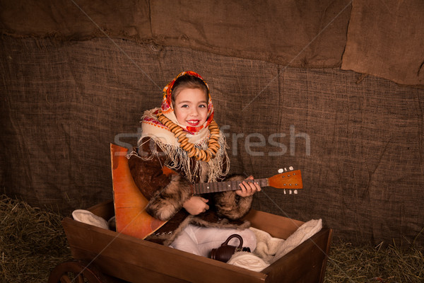 Beautiful russian girl in a shawl  sitting in a cart  Stock photo © Len44ik