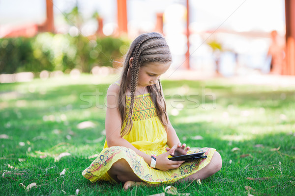 Cute little girl learning with tablet pc Stock photo © Len44ik