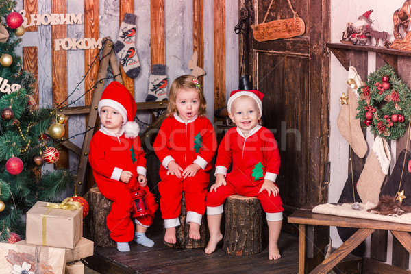 Happy little babys in Santa's costumes near Xmas tree Stock photo © Len44ik