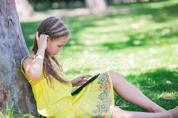 Cute little girl learning with tablet pc Stock photo © Len44ik