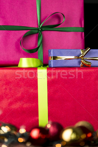 Three wrapped gifts, bowknots, spheres and glitters Stock photo © leowolfert