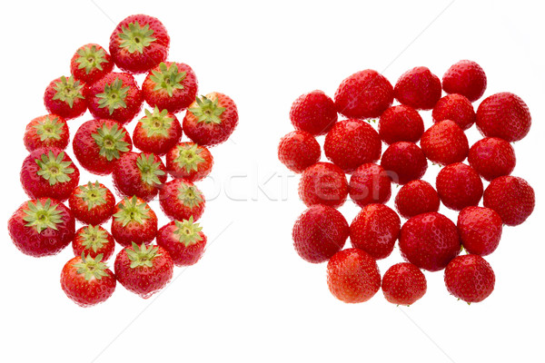 Strawberries Arranged In Two Groups Over White
 Stock photo © leowolfert