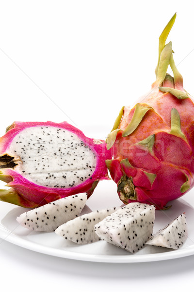Stock photo: Pitaya And Its Fruit Flesh On A White Plate