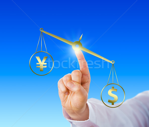 Dollar Outweighing The Yen On A Golden Balance Stock photo © leowolfert