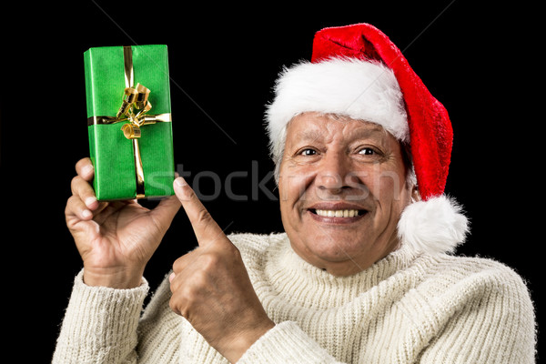 Gleeful Aged Man Pointing At Raised Green Present Stock photo © leowolfert
