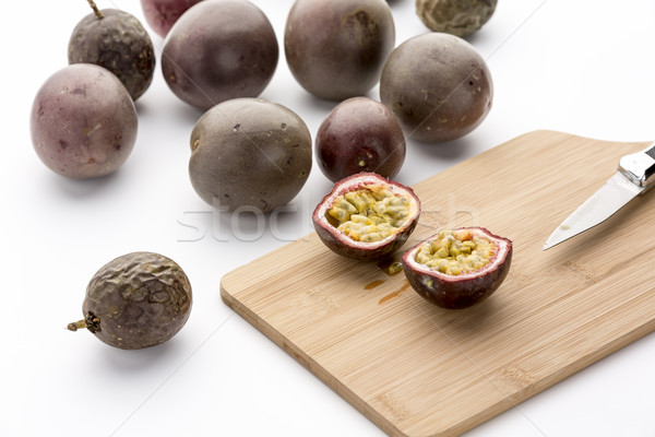 Freshly halved Passion Fruit On A Bamboo Board Stock photo © leowolfert
