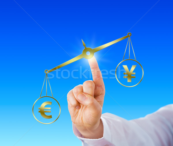 Stock photo: Euro Outweighing The Yen Sign On A Golden Scale