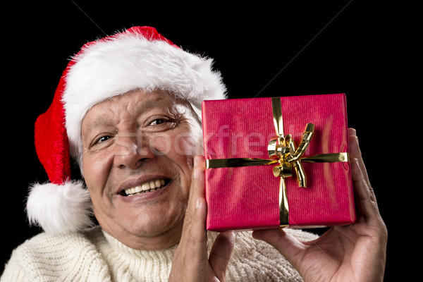 Smiling Old Man With Red Wrapped Christmas Gift Stock photo © leowolfert